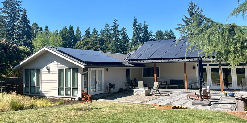 photo of a home with solar panels installed on a metal roof